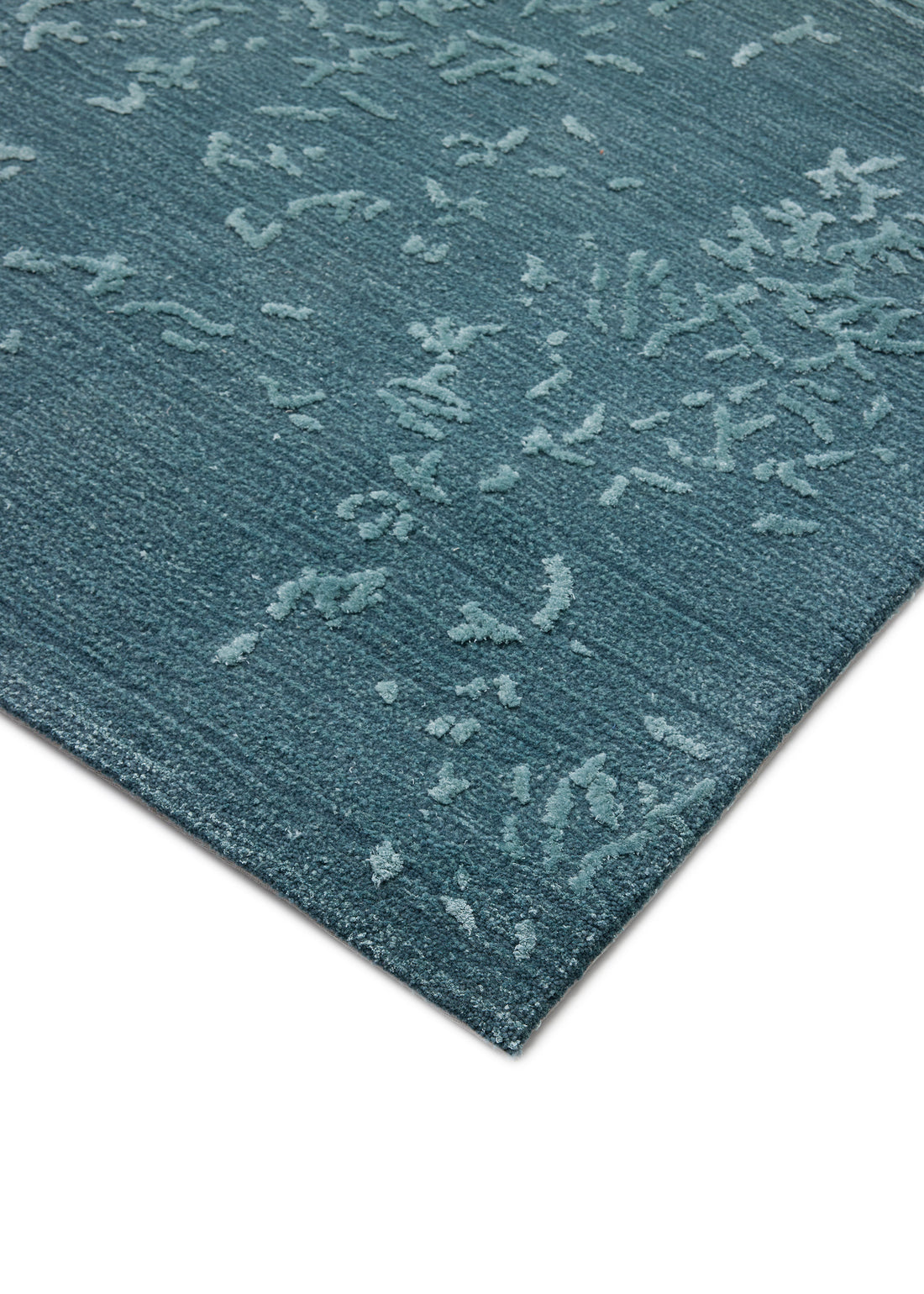 Close-up of the Blossom - Lagoon Blue rug. The abstract floral design adds a soft, subtle pattern to any space. thumbnail_1