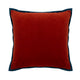 Red velvet cushion with navy piping. Luxurious throw pillow for sofa or bed decor.