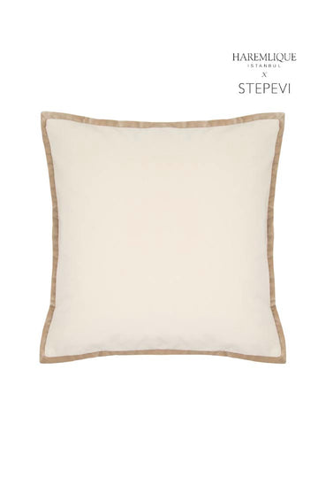 Primer plano de un cojín de terciopelo en tonos crema y camel. Detalle decorativo de la colección HAREMLIQUE Istanbul x STEPEVI.
