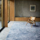 Lagoon Blue Blossom rug displayed in a modern living space with wood accents, showcasing its design and color. thumbnail_2