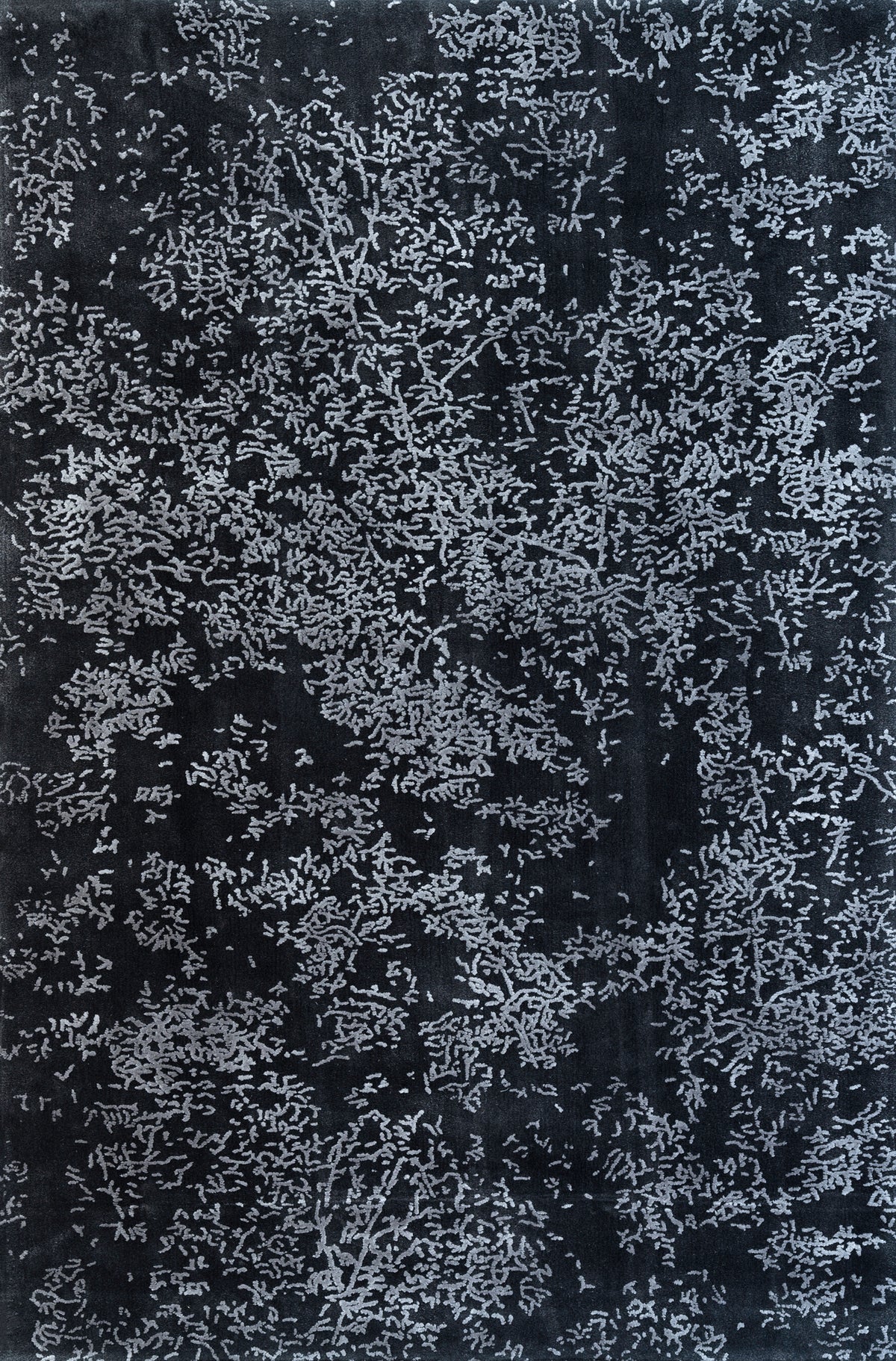 Close-up of the "Blossom" rug in titanium & pebble gray, showcasing its abstract floral-inspired pattern. Ideal for modern rooms