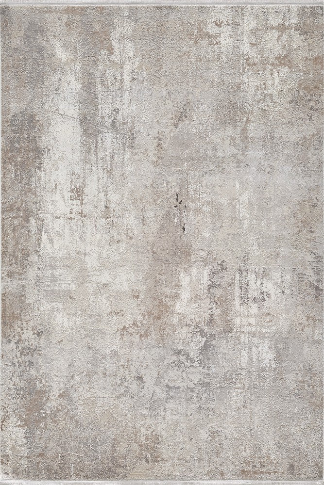 Close-up view of a "Terrain" area rug, showcasing its distressed, abstract pattern and neutral color palette.