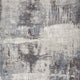 Textured "Fracture" area rug showcasing an abstract pattern with gray, beige, and blue hues, ideal for modern home decor.