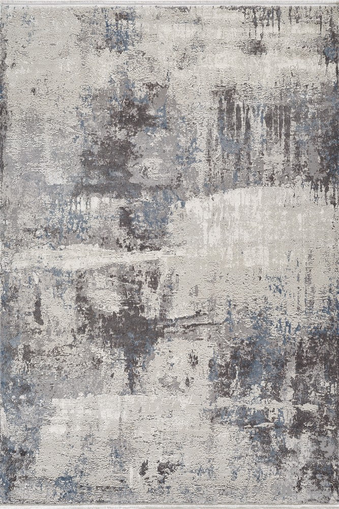 Textured "Fracture" area rug showcasing an abstract pattern with gray, beige, and blue hues, ideal for modern home decor.